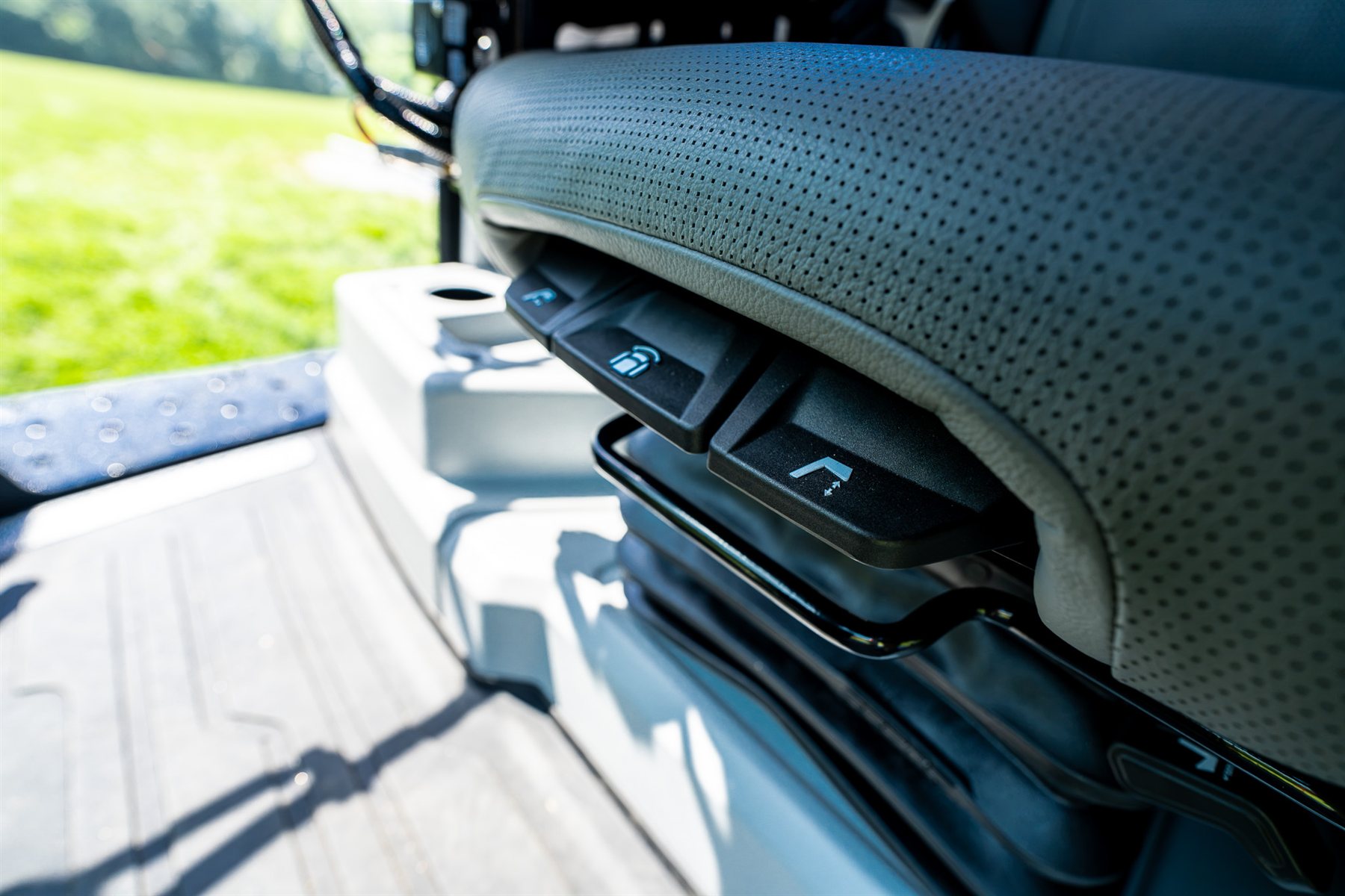 Detail of the new perforated leather operator seat and its side controls